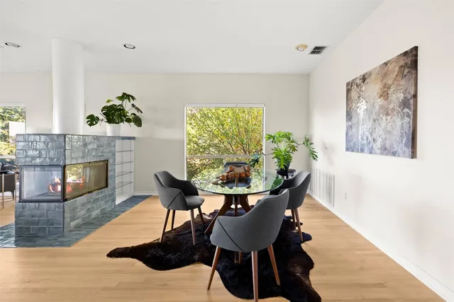 a living room with furniture a table and wooden floor