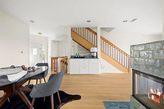 a living room with furniture fireplace and a window