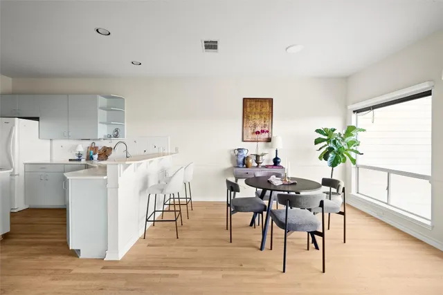 a kitchen with sink a refrigerator and cabinets