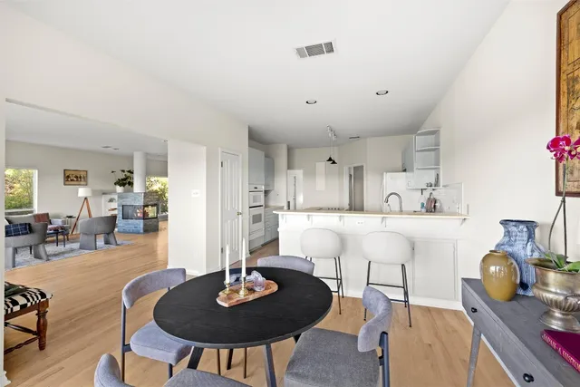 a kitchen with stainless steel appliances kitchen island a refrigerator sink and wooden cabinets