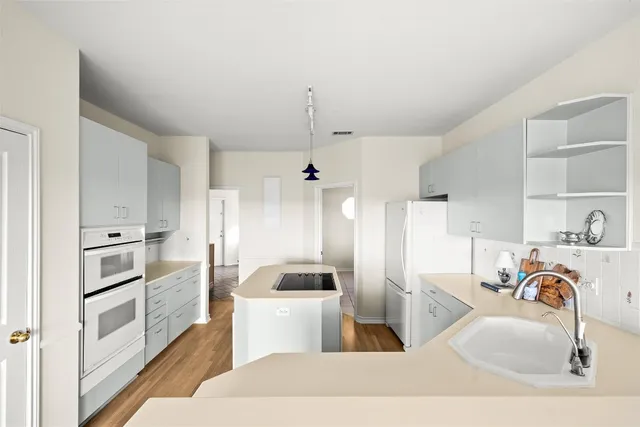 a kitchen with a sink stainless steel appliances and cabinets