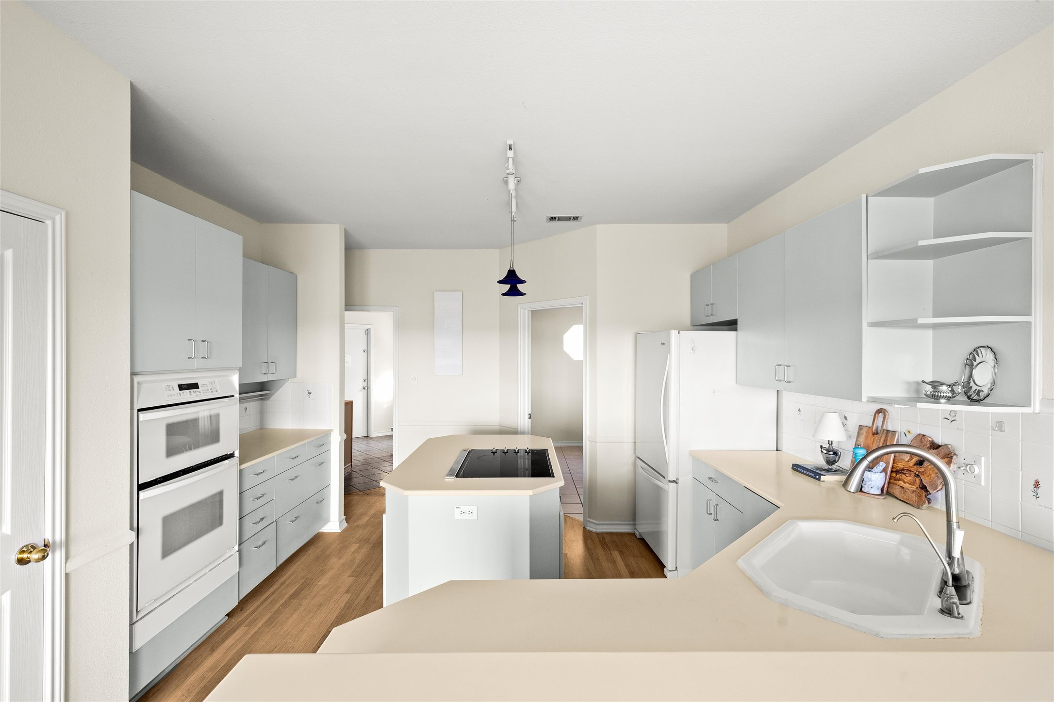 5926 Northwest Place Austin, TX 78731 - Photo 24 of 40 a kitchen with white cabinets and stainless steel appliances