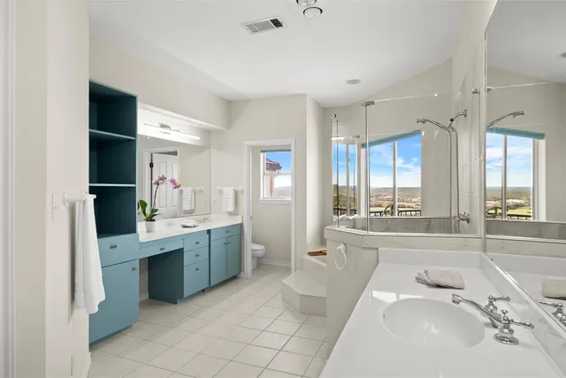 a bathroom with a tub sink and mirror
