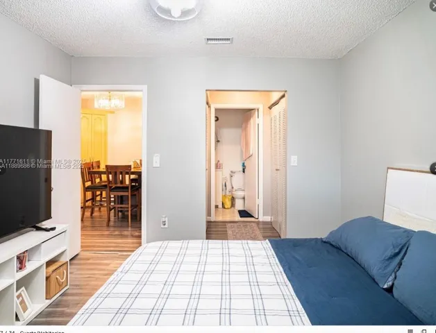 a bedroom with a bed and flat screen tv