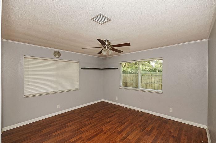 13387 Barwick Road Delray Beach, FL 33445 - Photo 20 of 28 a view of an empty room with wooden floor and a window