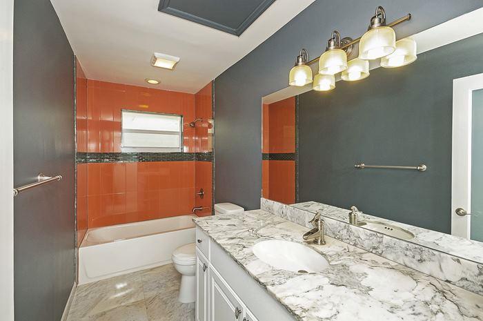 13387 Barwick Road Delray Beach, FL 33445 - Photo 21 of 28 a bathroom with a granite countertop sink a toilet and a shower