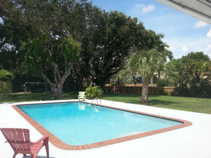 13387 Barwick Road Delray Beach, FL 33445 - Photo 25 of 28 a view of a swimming pool with a yard