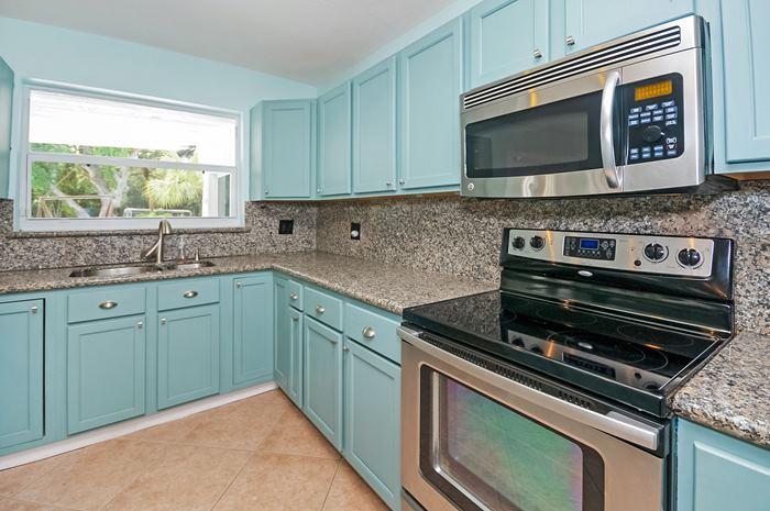 13387 Barwick Road Delray Beach, FL 33445 - Photo 6 of 28 a kitchen with granite countertop cabinets stainless steel appliances and window