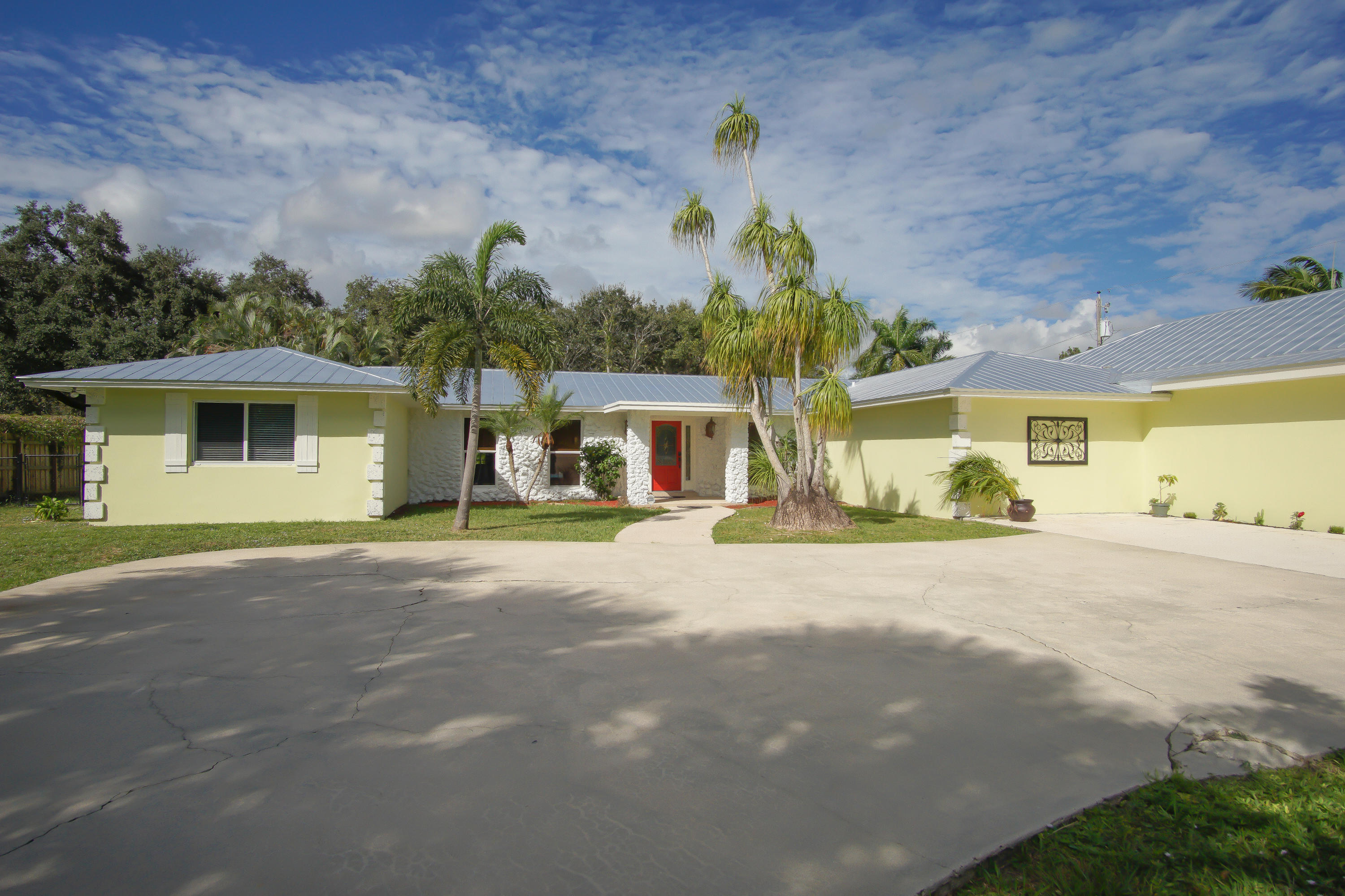 13387 Barwick Road Delray Beach, FL 33445 - Photo 7 of 28 a front view of a house with a yard and garage