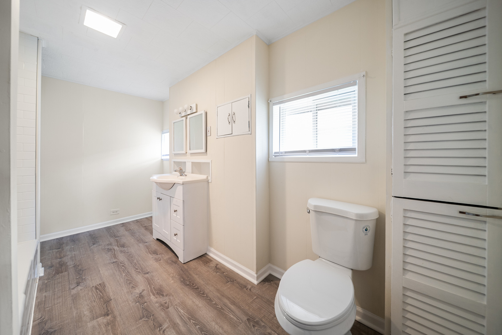 7120 41st Street Stickney, IL 60402 - Photo 8 of 13 a white toilet sitting next to a bathroom sink