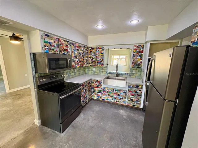 a kitchen with refrigerator and window