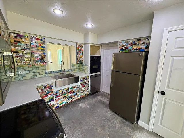 a kitchen with refrigerator and cabinets