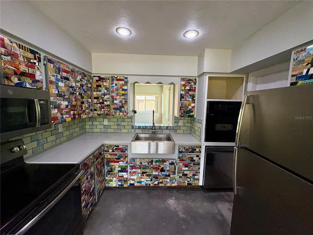 a room with furniture a flat screen tv and a refrigerator