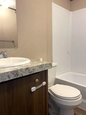 a bathroom with a toilet and a bathtub