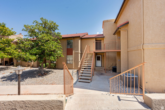 161 West 950 South, Unit C5 St. George, UT 84770 - Photo 2 of 14 Multi-level stucco exterior featuring a terra cotta tile roof and a second-story balcony