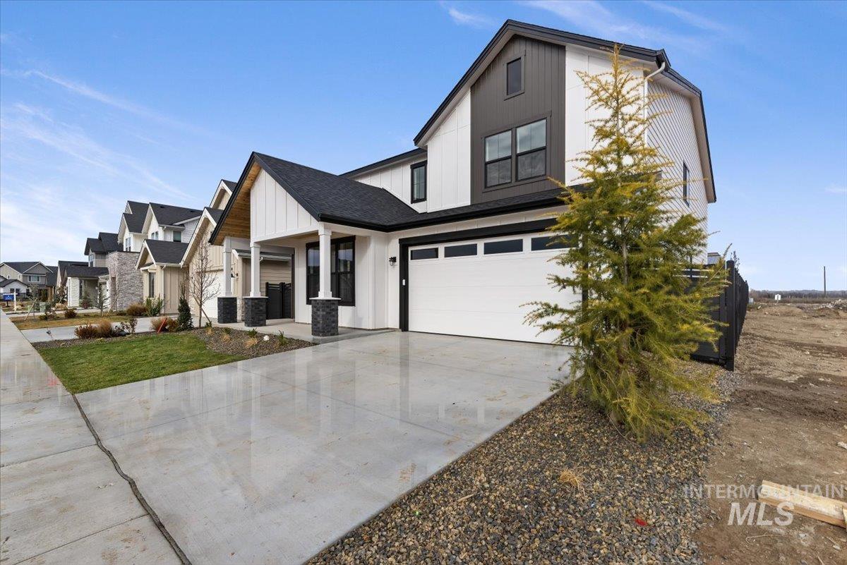 7586 West Centerline Street, Unit FREMONT Eagle, ID 83616 - Photo 6 of 37 Modern farmhouse style home featuring an attached garage, board and batten siding, concrete driveway, a porch, and a residential view
