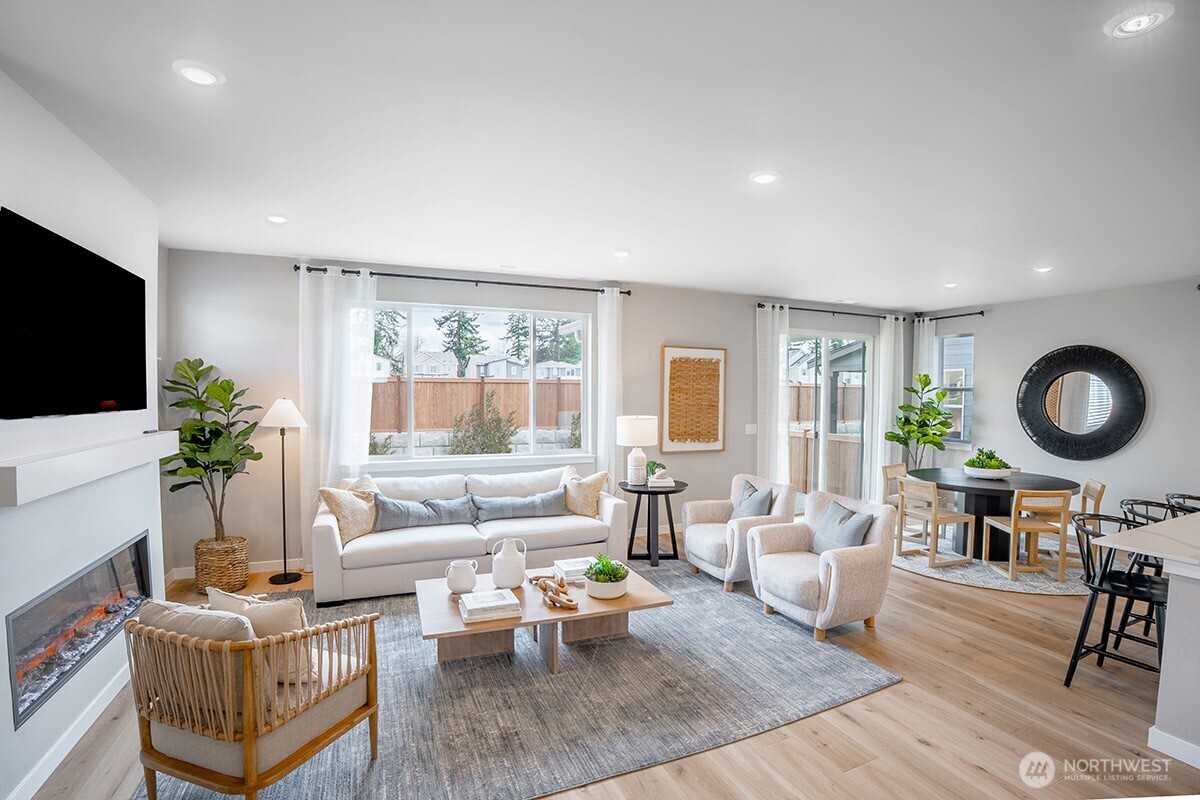 24318 13 Avenue Southeast, Unit CR10 Bothell, WA 98021 - Photo 2 of 6 a living room with furniture and a flat screen tv