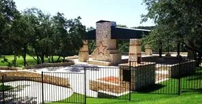 a view of swimming pool with a table and chairs in the patio