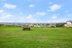 a view of a lake with houses in the back