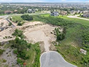 an aerial view of a house with a yard and lake view