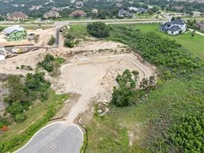 an aerial view of a house with a yard and lake view