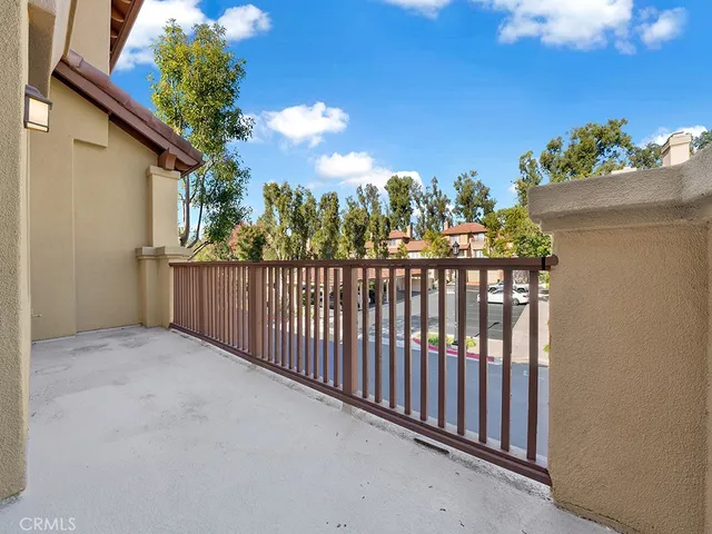 a view of a pathway of a house with wooden floor and fence