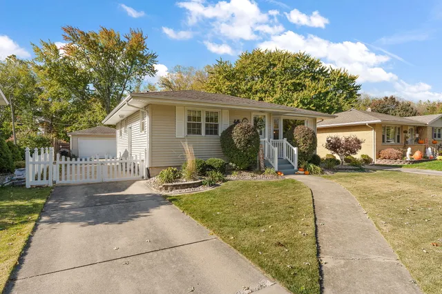 a front view of house with yard outdoor seating and barbeque oven