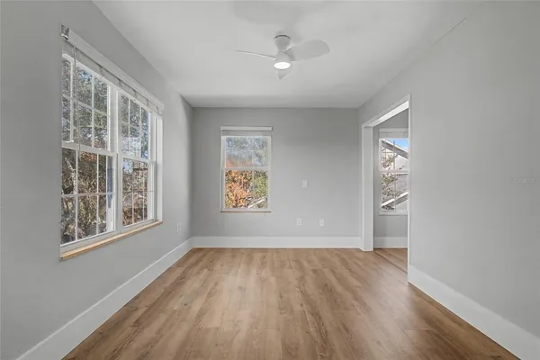 wooden floor in an empty room with a window