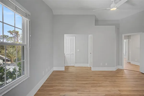 a view of a livingroom with wooden floor and window