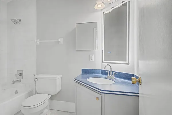 a bathroom with a sink toilet vanity and shower