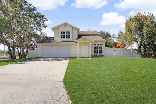 a front view of a house with a garden and yard