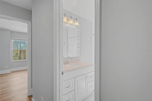 a bathroom with a light fixture and a mirror