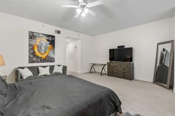 a bedroom with a bed and a television