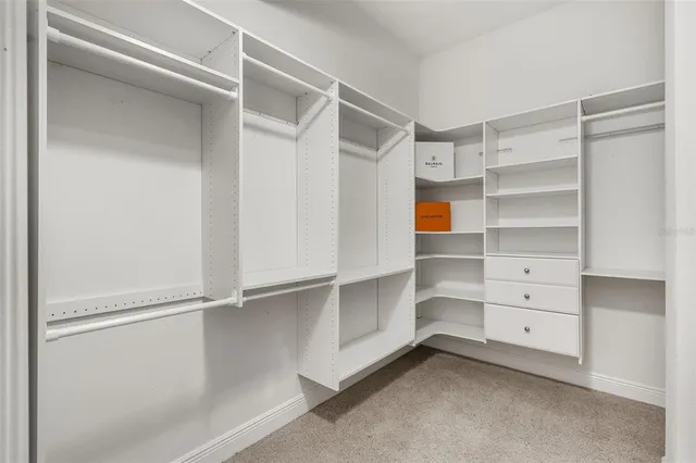 a spacious bathroom with a toilet sink and mirror