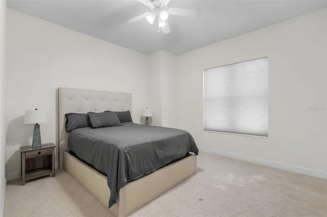 a spacious bedroom with a bed and a chandelier