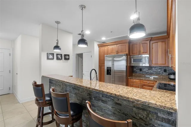 a kitchen with stainless steel appliances granite countertop a stove sink and cabinets