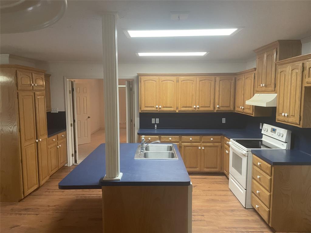 210 Vz County Road 2139 Canton, TX 75103 - Photo 12 of 18 a kitchen with stainless steel appliances granite countertop a sink wooden cabinets and a refrigerator
