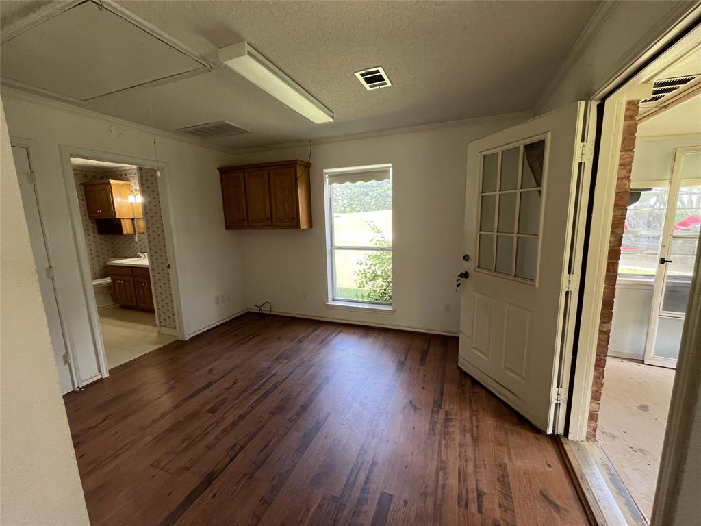 210 Vz County Road 2139 Canton, TX 75103 - Photo 15 of 18 an empty room with wooden floor and windows
