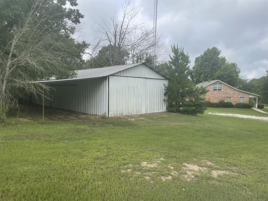 210 Vz County Road 2139 Canton, TX 75103 - Photo 8 of 18 a backyard of a house with plants and large tree