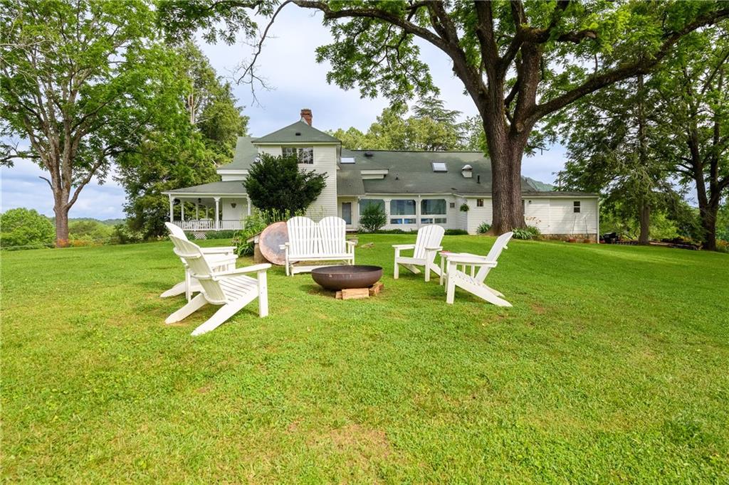 1526 Highway 255 Sautee Nacoochee, GA 30571 - Photo 11 of 61 a white bench sitting in the grass near a house