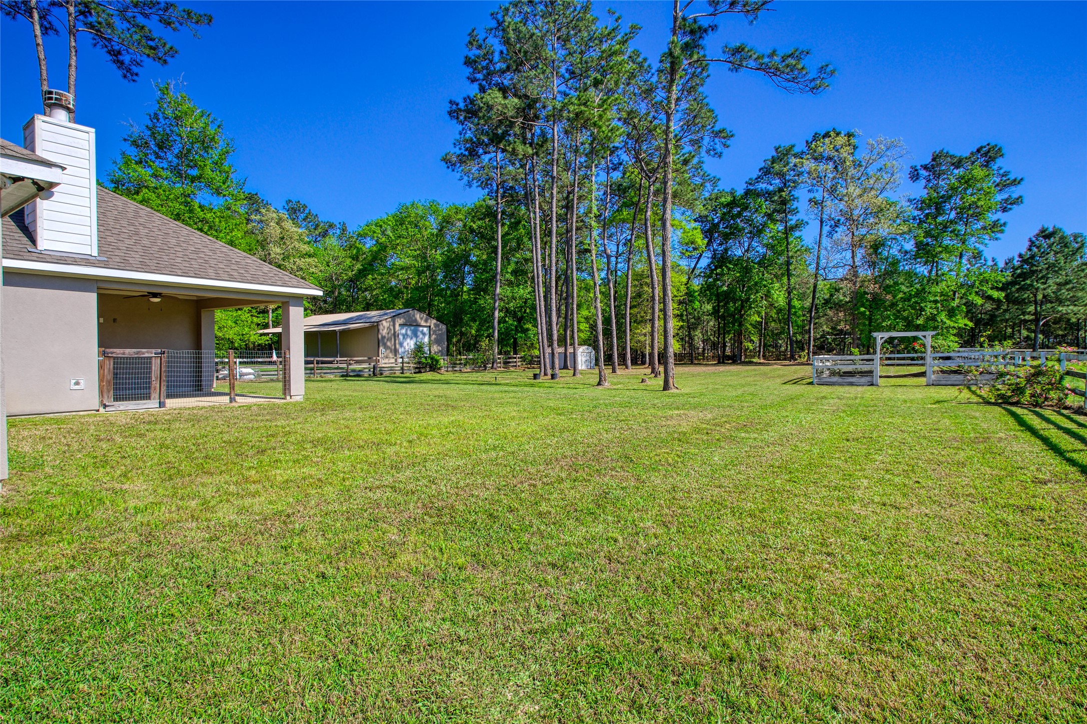 27684 Rio Blanco Drive Splendora, TX 77372 - Photo 26 of 31 a backyard of a house with lots of green space and fountain