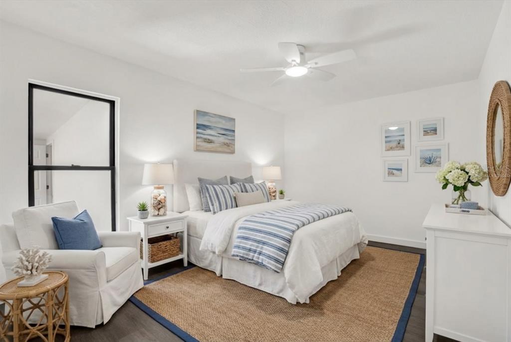 1955 Gilbert Street Clearwater, FL 33765 - Photo 12 of 24 a bedroom with a bed couch and a potted plant