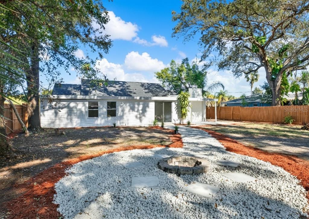 1955 Gilbert Street Clearwater, FL 33765 - Photo 21 of 24 a view of backyard of house with outdoor seating