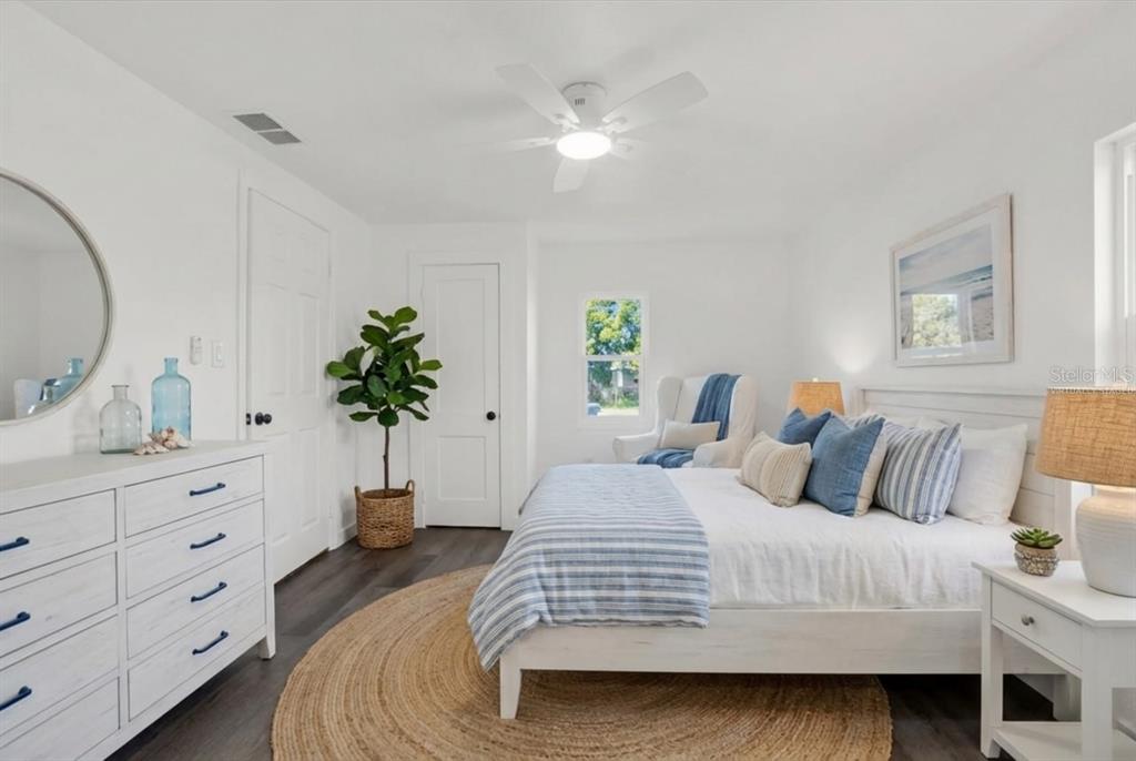 1955 Gilbert Street Clearwater, FL 33765 - Photo 6 of 24 a bedroom with a large bed and a potted plant on the dresser