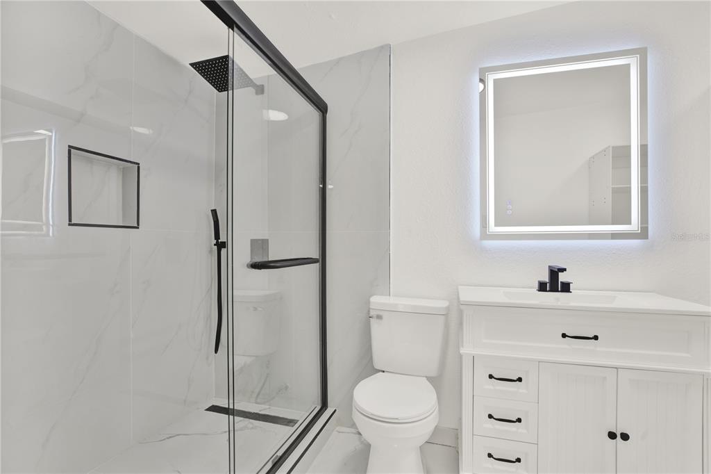 1955 Gilbert Street Clearwater, FL 33765 - Photo 8 of 24 a bathroom with a sink toilet and shower