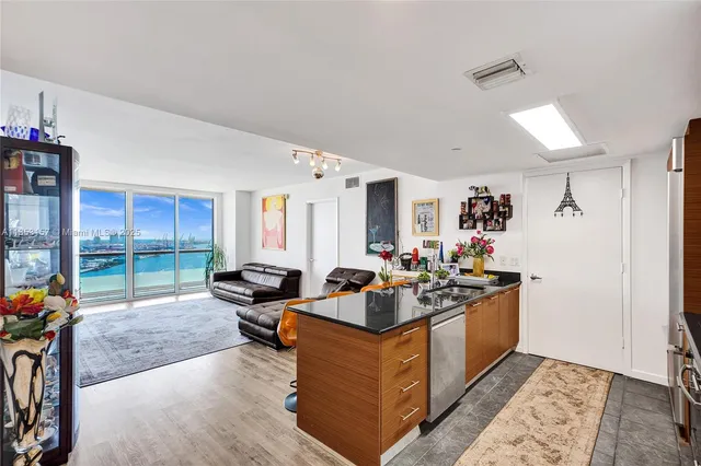 a living room with furniture a flat screen tv and a floor to ceiling window