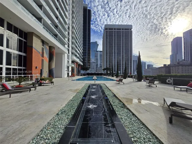 a view of a living room with balcony and furniture