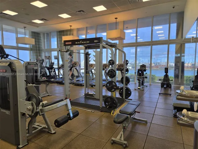 a view of a workspace with furniture and wooden floor