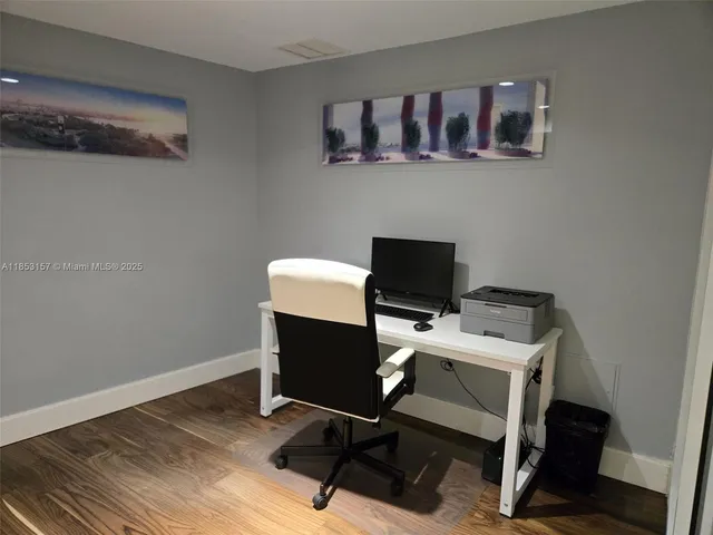 a view of a house with a yard and palm trees