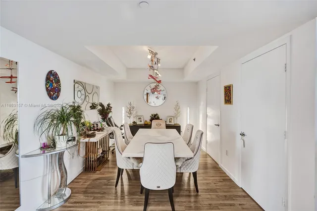 a view of a dining room with furniture wooden floor and a chandelier